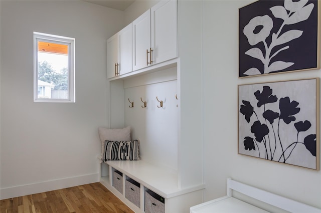 mudroom with baseboards and light wood-style flooring