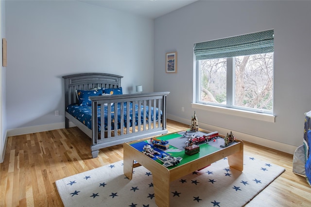 bedroom featuring baseboards and light wood-style floors