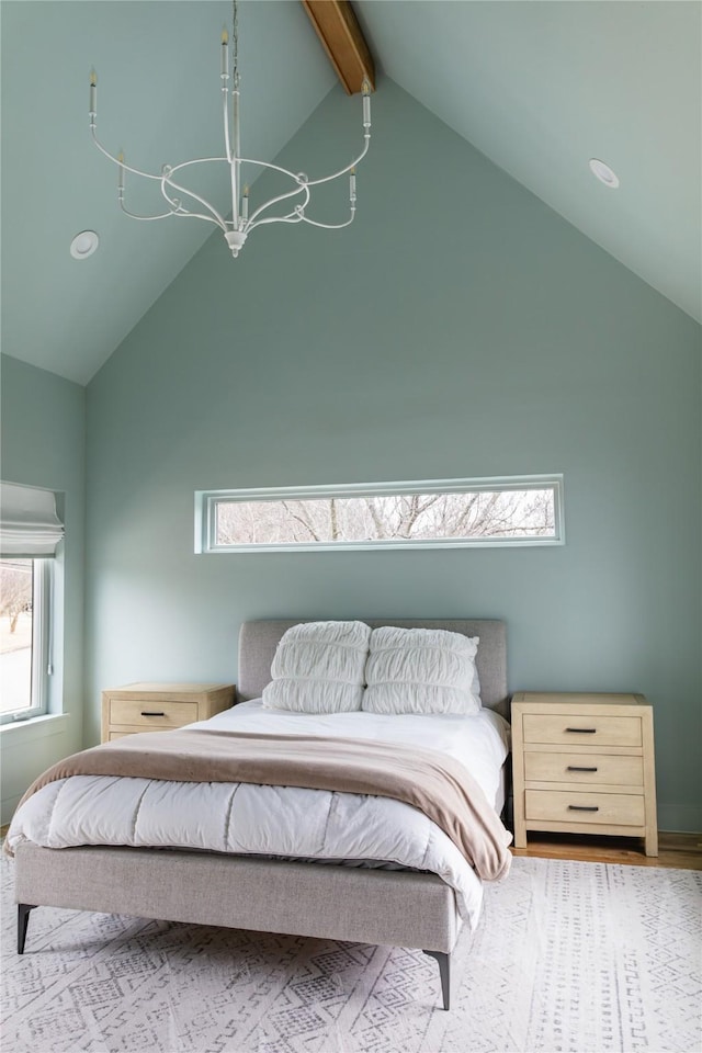 bedroom with high vaulted ceiling, multiple windows, beamed ceiling, and a notable chandelier