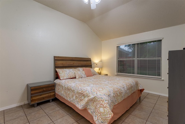 bedroom with a ceiling fan, baseboards, vaulted ceiling, and light tile patterned floors