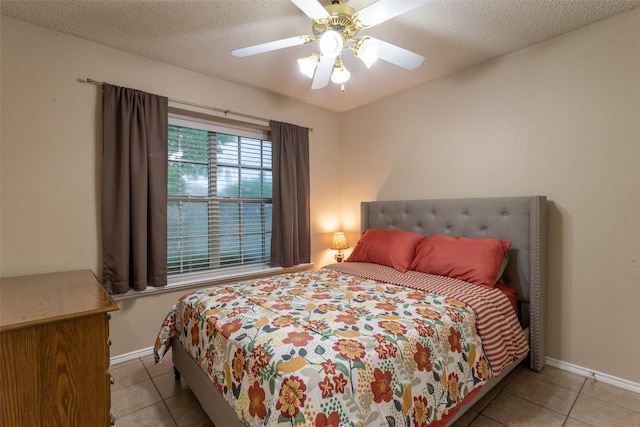 bedroom featuring tile patterned floors, baseboards, and ceiling fan