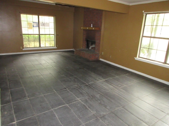 4231 Scenic Dr, Shreveport, LA 71119 - unfurnished living room featuring plenty of natural light, a fireplace, and dark tile patterned flooring