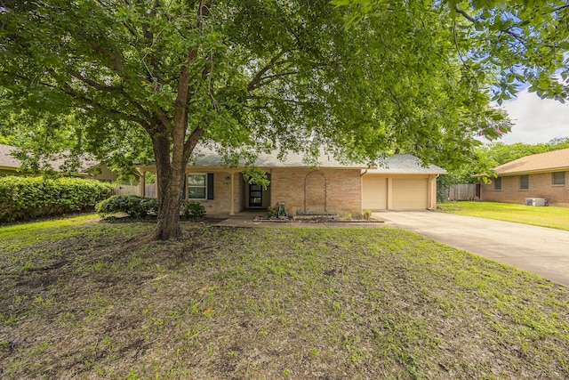 view of front of home with a garage, driveway, and brick siding