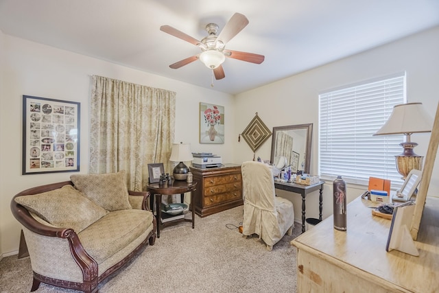 home office featuring light carpet and ceiling fan