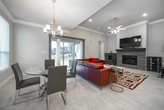 7005 Homestead Dr, Mckinney, TX 75070 - dining room featuring crown molding, arched walkways, a glass covered fireplace, ceiling fan with notable chandelier, and visible vents