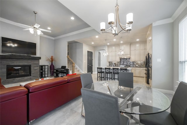 7005 Homestead Dr, Mckinney, TX 75070 - living area with crown molding, arched walkways, a fireplace with flush hearth, ceiling fan with notable chandelier, and recessed lighting