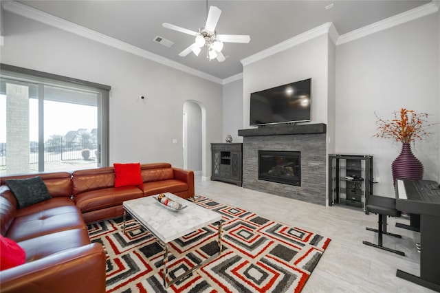 7005 Homestead Dr, Mckinney, TX 75070 - tiled living area featuring visible vents, crown molding, a stone fireplace, ceiling fan, and arched walkways