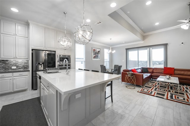 7005 Homestead Dr, Mckinney, TX 75070 - kitchen featuring visible vents, open floor plan, stainless steel microwave, a sink, and refrigerator with ice dispenser