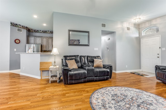 living area with recessed lighting, baseboards, visible vents, and light wood-style floors