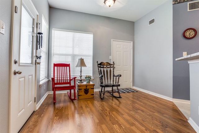 sitting room featuring baseboards, wood finished floors, and visible vents