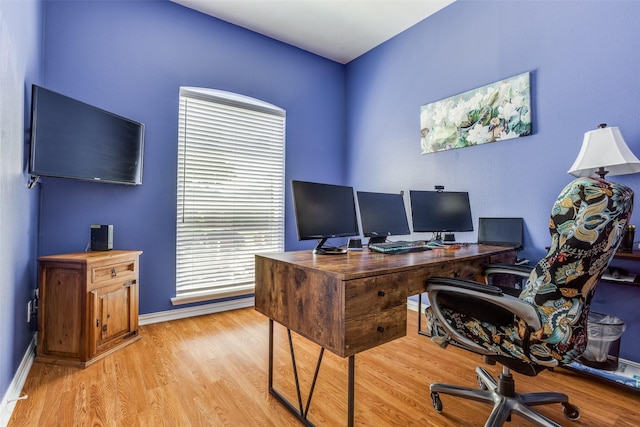 home office featuring baseboards and wood finished floors