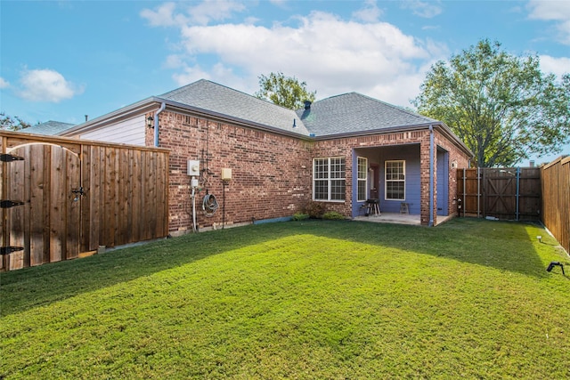 back of house featuring brick siding, a patio, a gate, and roof with shingles