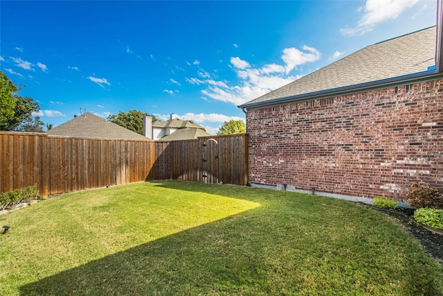 view of yard with a fenced backyard