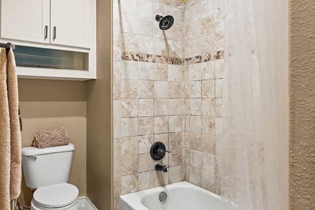 bathroom featuring toilet and tub / shower combination