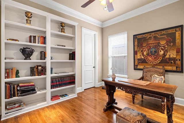 office featuring a ceiling fan, wood finished floors, crown molding, and baseboards