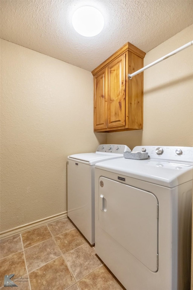 270 Alexandra Dr, Tuscola, TX 79562 - clothes washing area with washing machine and clothes dryer, cabinet space, a textured ceiling, and baseboards