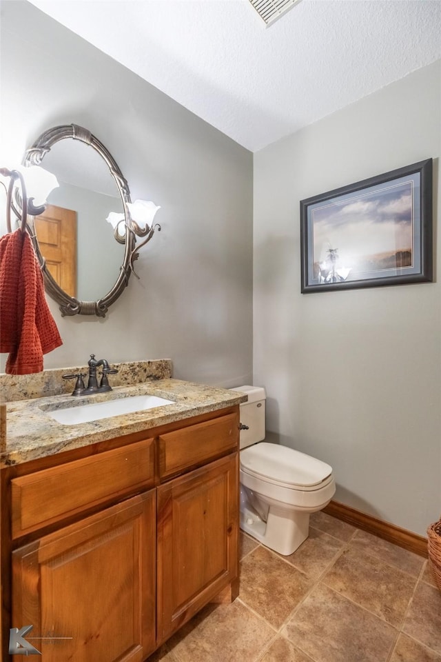 270 Alexandra Dr, Tuscola, TX 79562 - bathroom featuring toilet, vanity, a textured ceiling, and baseboards