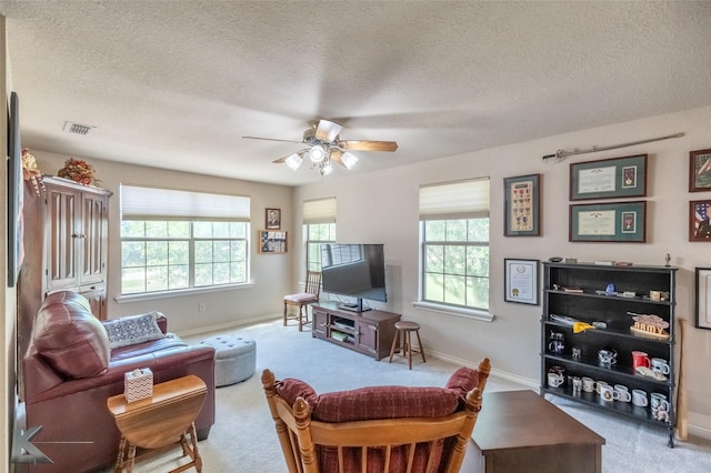 270 Alexandra Dr, Tuscola, TX 79562 - carpeted living room featuring a ceiling fan, a textured ceiling, and baseboards