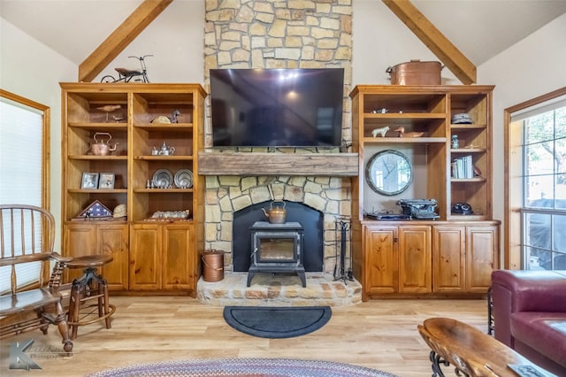 270 Alexandra Dr, Tuscola, TX 79562 - living room featuring lofted ceiling, a wood stove, and light wood finished floors