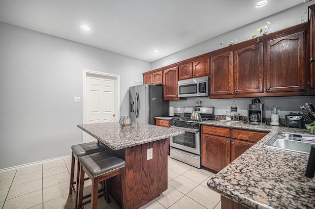 2100 Leandra Ln, Fort Worth, TX 76131 - kitchen with a sink, appliances with stainless steel finishes, a center island, and light tile patterned flooring