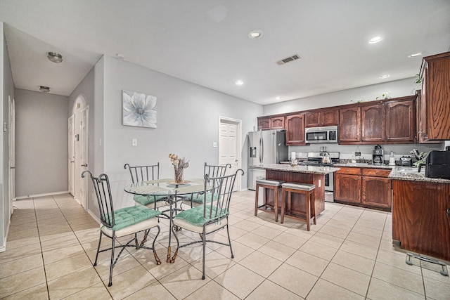 2100 Leandra Ln, Fort Worth, TX 76131 - kitchen featuring visible vents, a kitchen island, light tile patterned flooring, recessed lighting, and stainless steel appliances