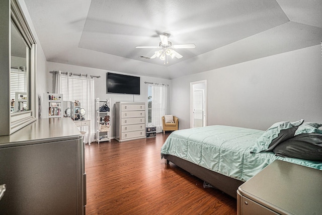 2100 Leandra Ln, Fort Worth, TX 76131 - bedroom featuring multiple windows, a tray ceiling, dark wood-style floors, and visible vents