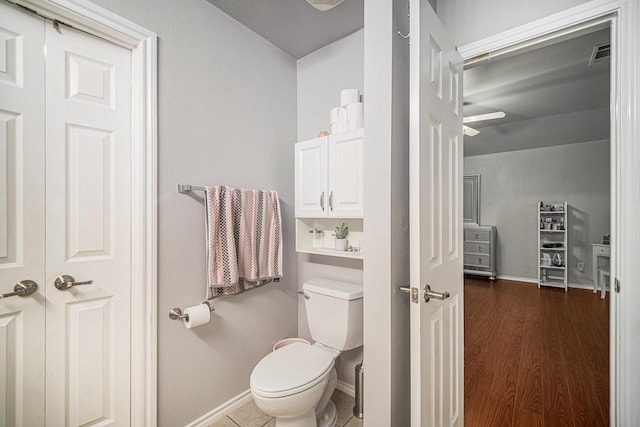 2100 Leandra Ln, Fort Worth, TX 76131 - bathroom with visible vents, wood finished floors, toilet, baseboards, and ceiling fan