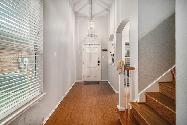 2100 Leandra Ln, Fort Worth, TX 76131 - entrance foyer with baseboards, arched walkways, stairs, and wood finished floors