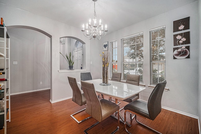 2100 Leandra Ln, Fort Worth, TX 76131 - dining space with arched walkways, baseboards, a notable chandelier, and wood finished floors