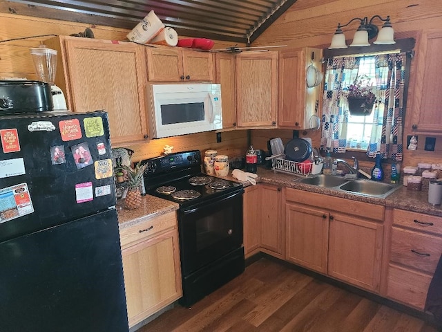 kitchen with a sink, black appliances, and dark wood-type flooring