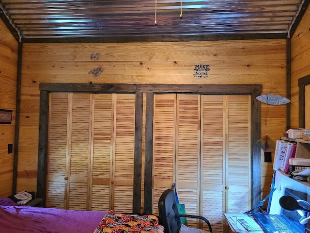 bedroom with wooden walls