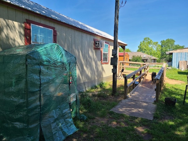 view of home's exterior with fence and metal roof