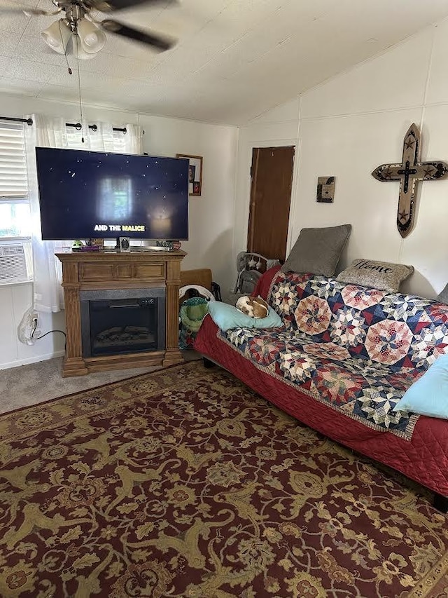 carpeted living area featuring cooling unit, ceiling fan, lofted ceiling, and a fireplace