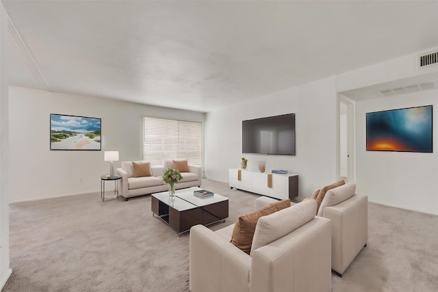 living area featuring light carpet and baseboards