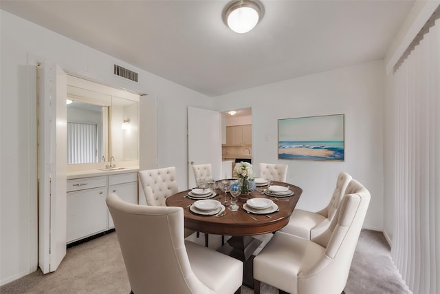 dining room with light carpet and baseboards