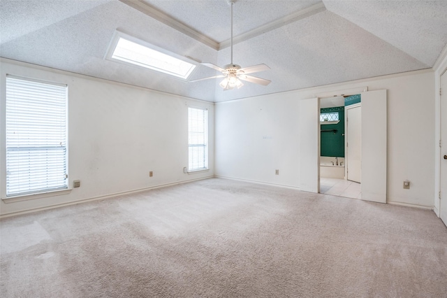 908 Willow Brook Dr, Allen, TX 75002 - carpeted spare room featuring vaulted ceiling with skylight, baseboards, ceiling fan, and a textured ceiling