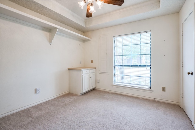 908 Willow Brook Dr, Allen, TX 75002 - spare room featuring a raised ceiling, ceiling fan, baseboards, and light colored carpet