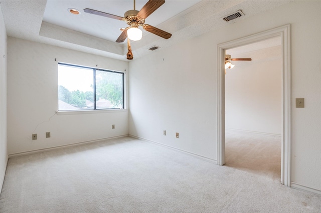 908 Willow Brook Dr, Allen, TX 75002 - carpeted spare room featuring baseboards, ceiling fan, visible vents, and a tray ceiling