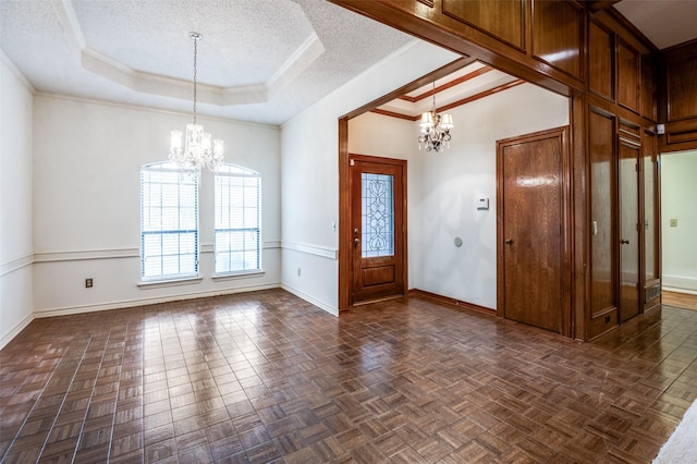 908 Willow Brook Dr, Allen, TX 75002 - entryway featuring baseboards, a raised ceiling, a textured ceiling, and a chandelier
