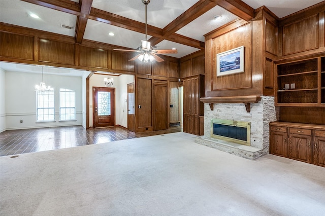 908 Willow Brook Dr, Allen, TX 75002 - unfurnished living room featuring a stone fireplace, beamed ceiling, ceiling fan with notable chandelier, dark colored carpet, and coffered ceiling