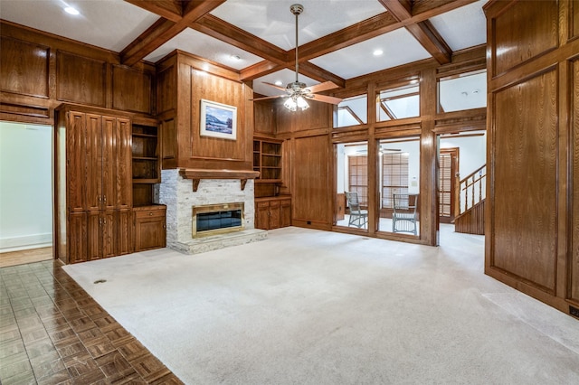908 Willow Brook Dr, Allen, TX 75002 - unfurnished living room with wooden walls, a fireplace, a ceiling fan, beamed ceiling, and coffered ceiling