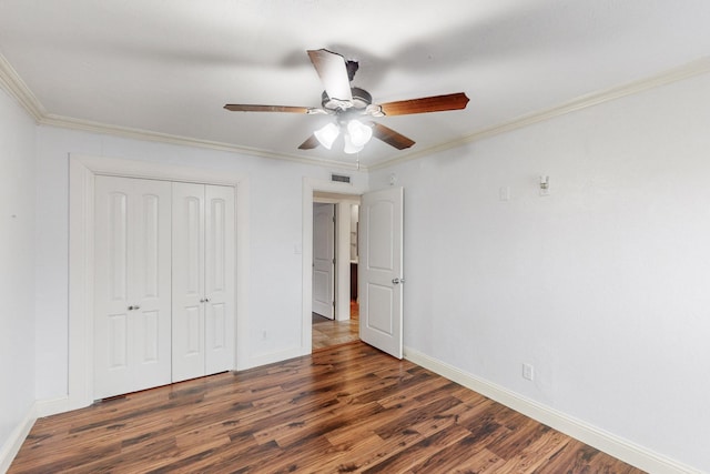 unfurnished bedroom with baseboards, wood finished floors, and visible vents