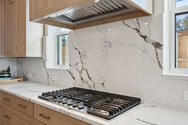 1 Mimosa Pl, Richardson, TX 75080 - kitchen with stainless steel gas stovetop, tasteful backsplash, light stone countertops, and custom exhaust hood