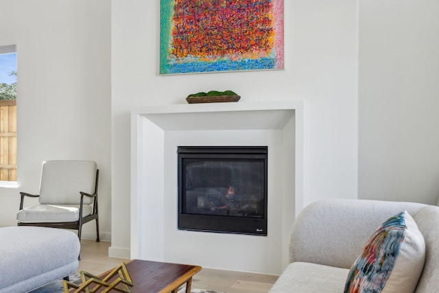 1 Mimosa Pl, Richardson, TX 75080 - living area featuring a glass covered fireplace and wood finished floors