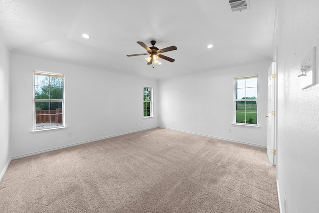 unfurnished room featuring visible vents, ceiling fan, and a healthy amount of sunlight