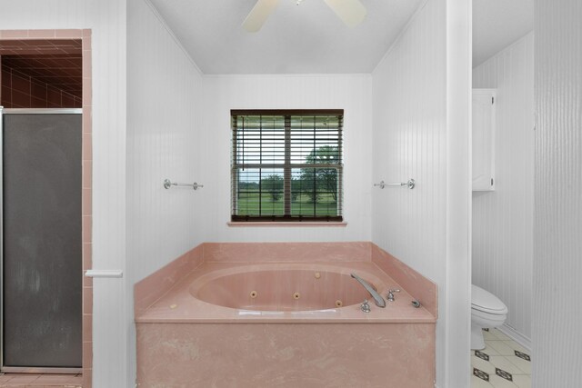 bathroom with a jetted tub, tile patterned floors, toilet, and a shower stall