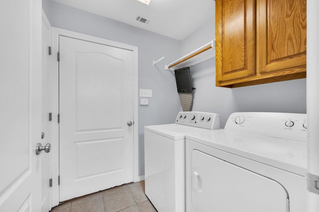 laundry area with cabinet space, light tile patterned flooring, visible vents, and washer and dryer