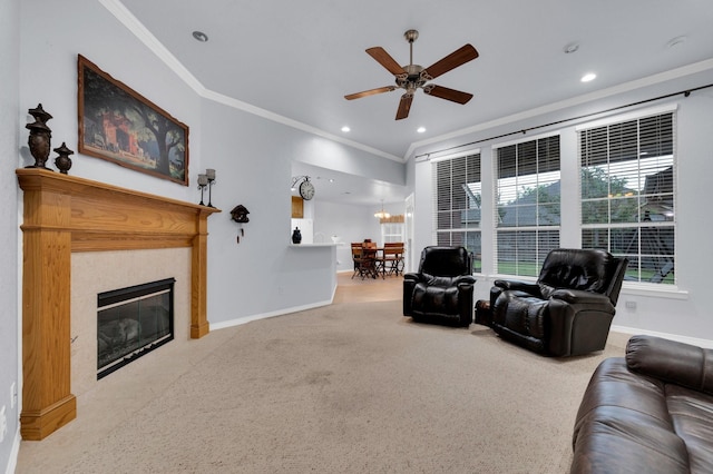 living area featuring crown molding, baseboards, ceiling fan, and a fireplace