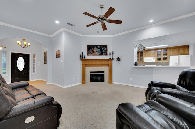 carpeted living area featuring visible vents, baseboards, recessed lighting, arched walkways, and ceiling fan with notable chandelier