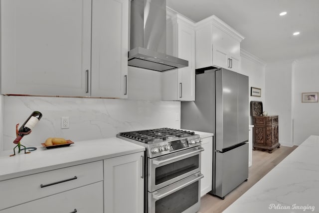 314 Gentilly Cir, Shreveport, LA 71106 - kitchen with wall chimney exhaust hood, stainless steel appliances, recessed lighting, light wood-type flooring, and backsplash